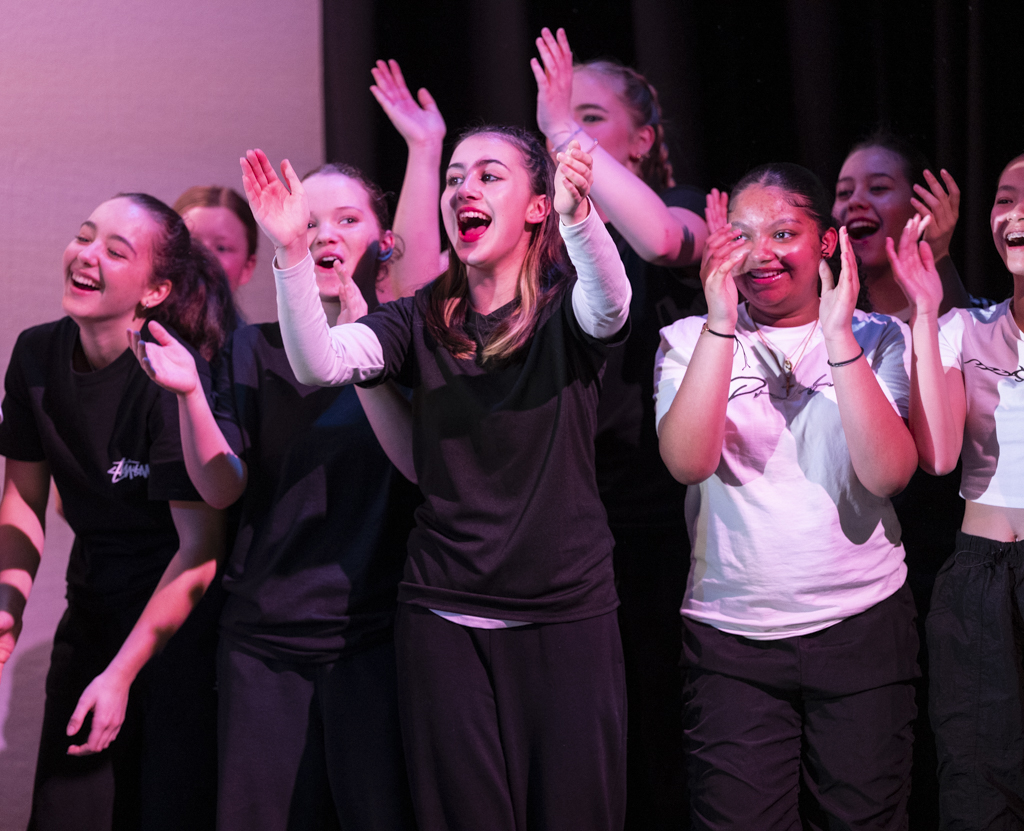 Group of dancers at the side lines cheering on other dancers